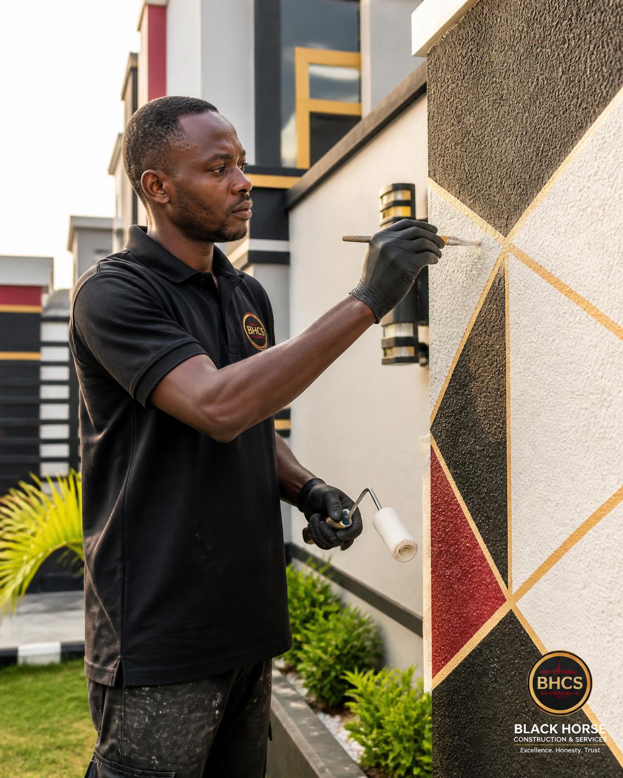 BHCS painter applying a decorative wall design on a modern Accra home